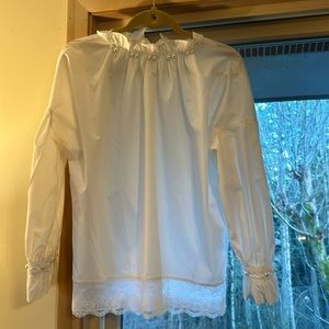 Faux Pearl button accent around front of neck & cuffs with lace around bottom